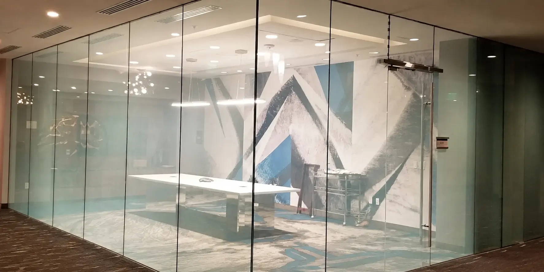 Smart film Dubai office glass partition in the crystal clear state at up to 95% clarity, with the room visible through the glass